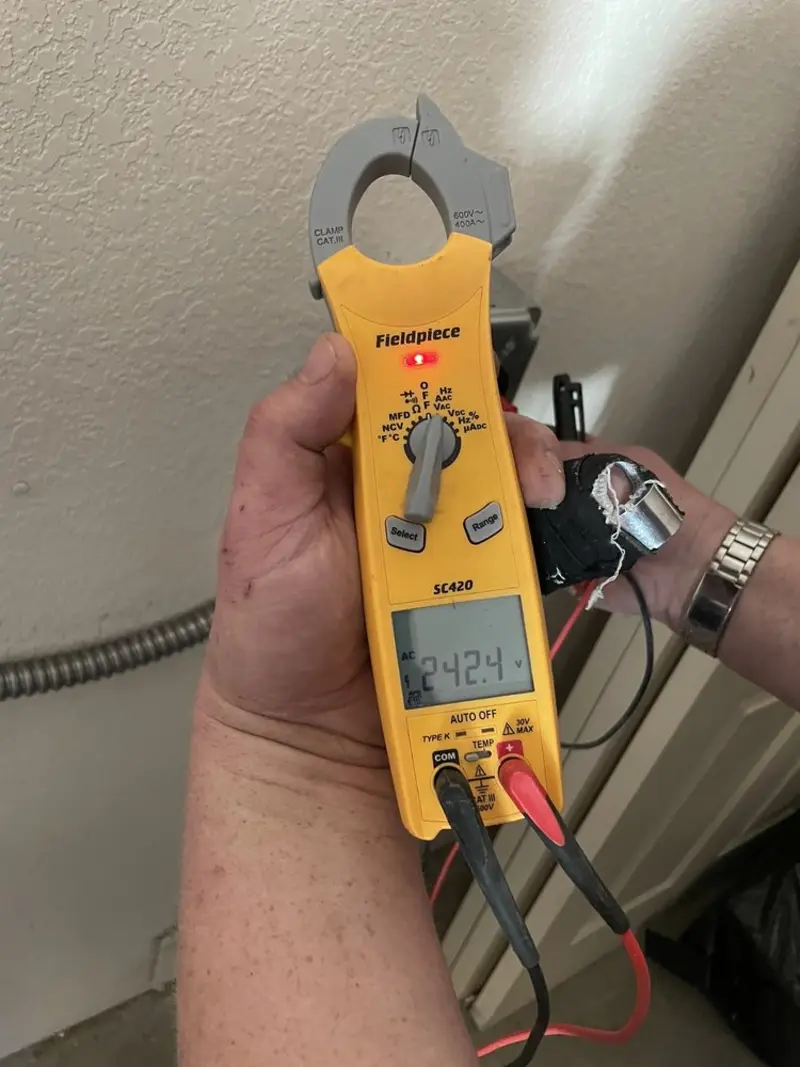 Voltage testing with clamp meter during Ceiling Fan Installation in Piney Point Village